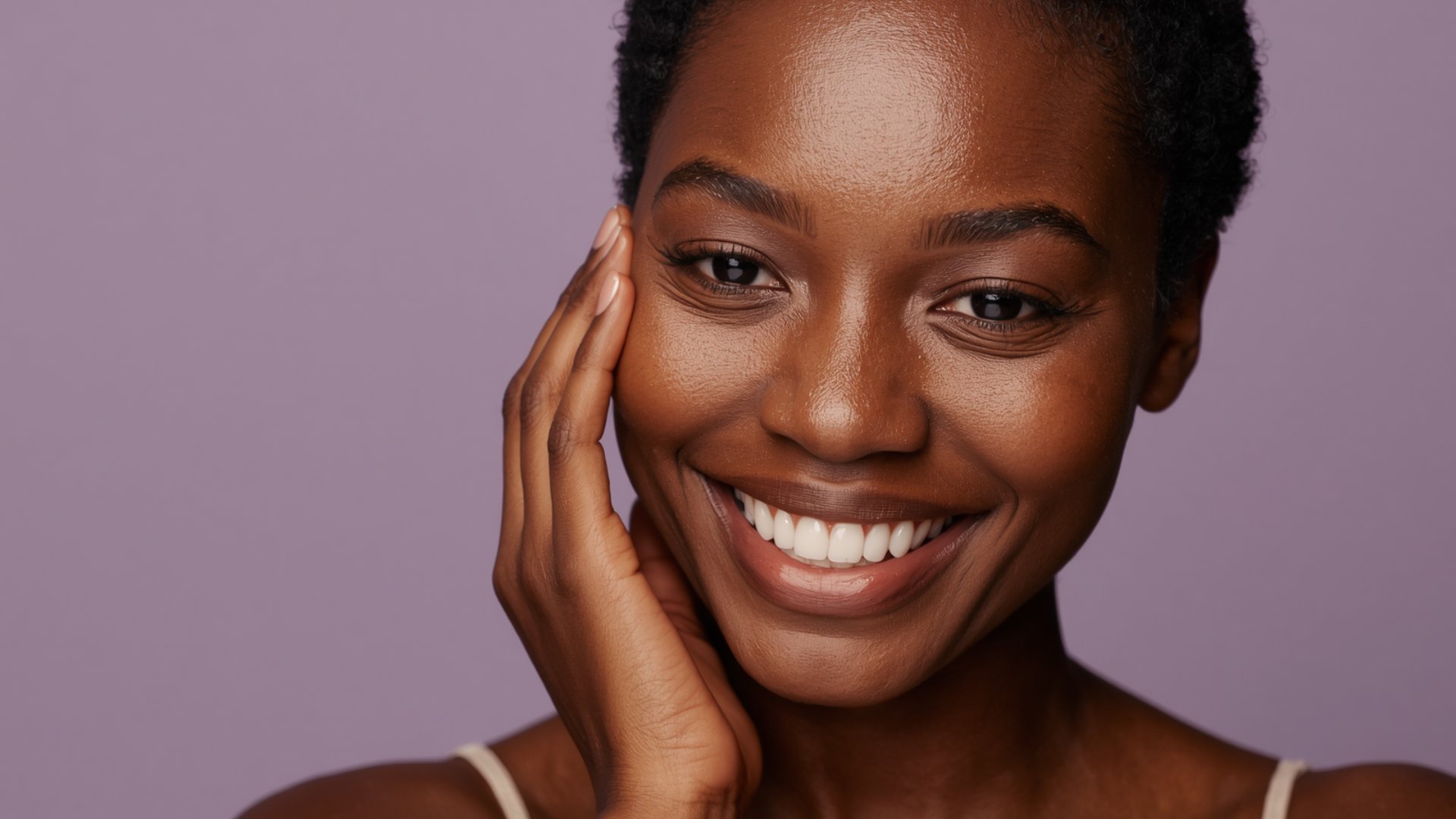 Black woman with natural hair and radiant smile, lavender background