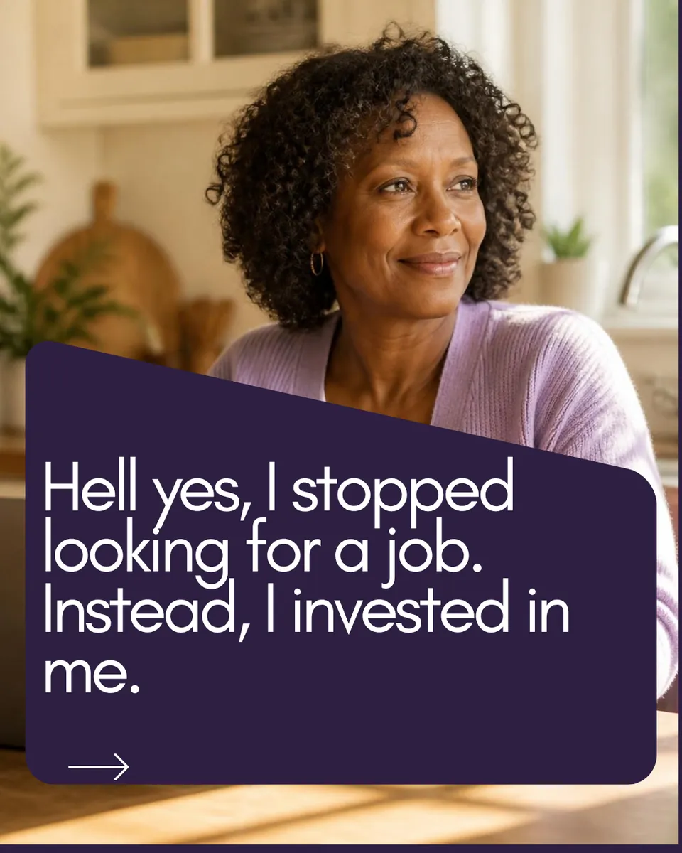 Hell yes, I stopped looking for a job. Instead, I invested in me. A Black woman in her 50s with natural curly hair smiles at a kitchen table with a laptop and coffee, wearing a lavender cardigan.